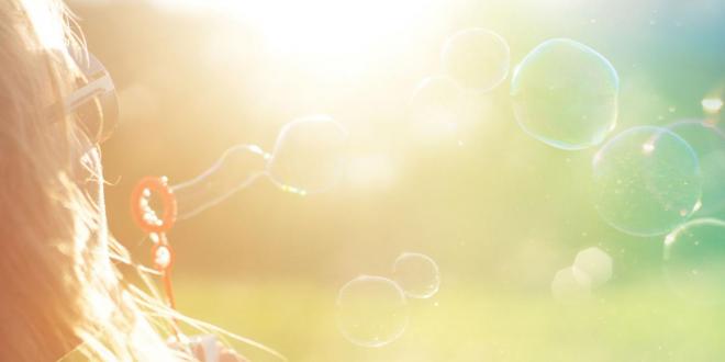 blowing bubbles in the sun