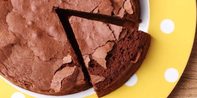 slicing into a gluten-free chocolate cake