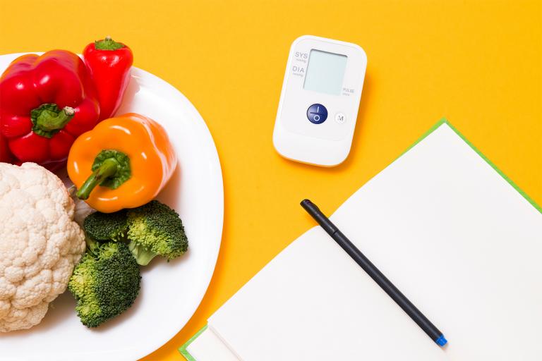 a journal, a blood pressure monitor, and a diet journal