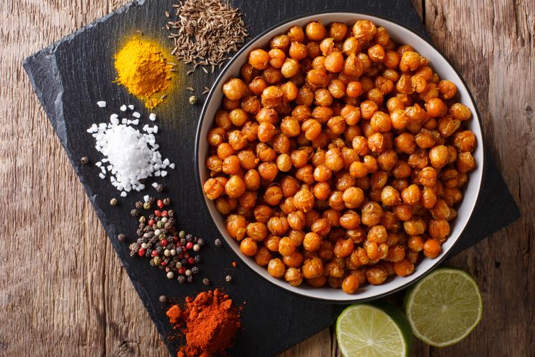 a bowl of roasted chickpeas and the spices used making them